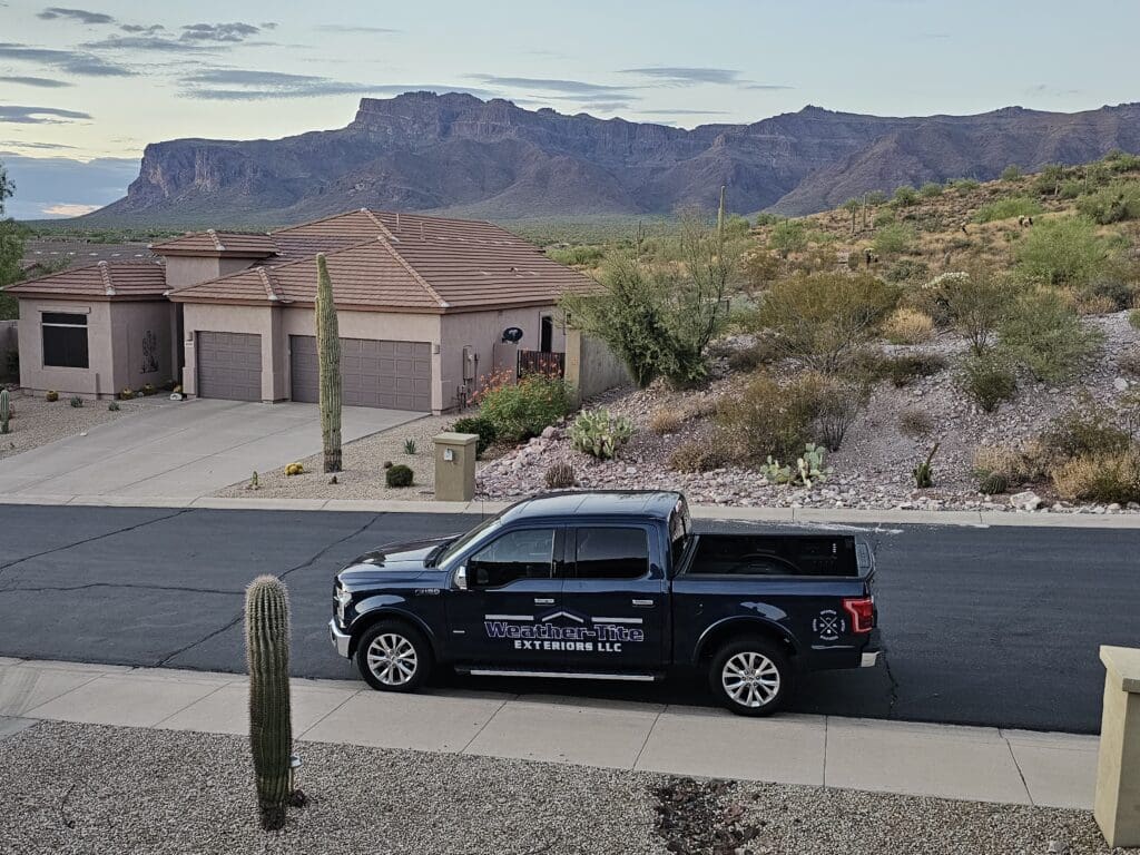 Weather-Tite Exteriors LLC truck parked in front of a home in Mesa, Arizona.