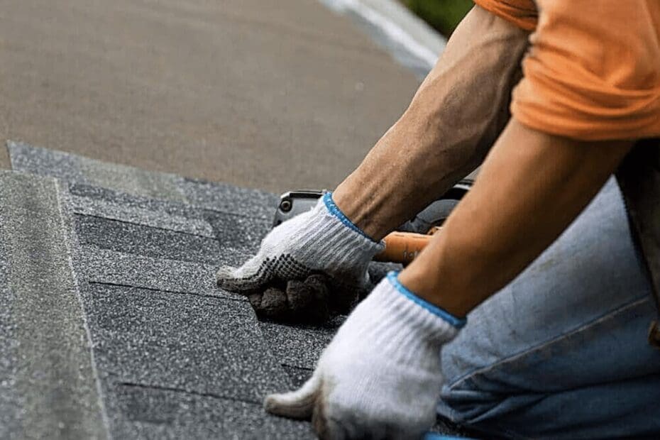 Composite shingles: The image shows a roofer installing the shingles to the roof.