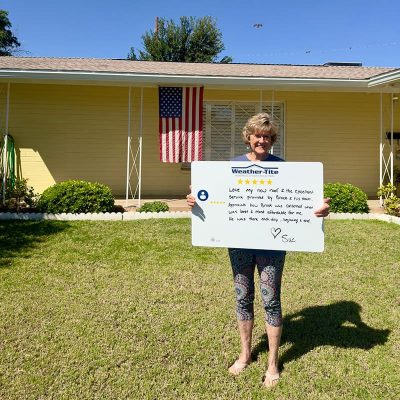 Satisfied Homeowner holding up her review card